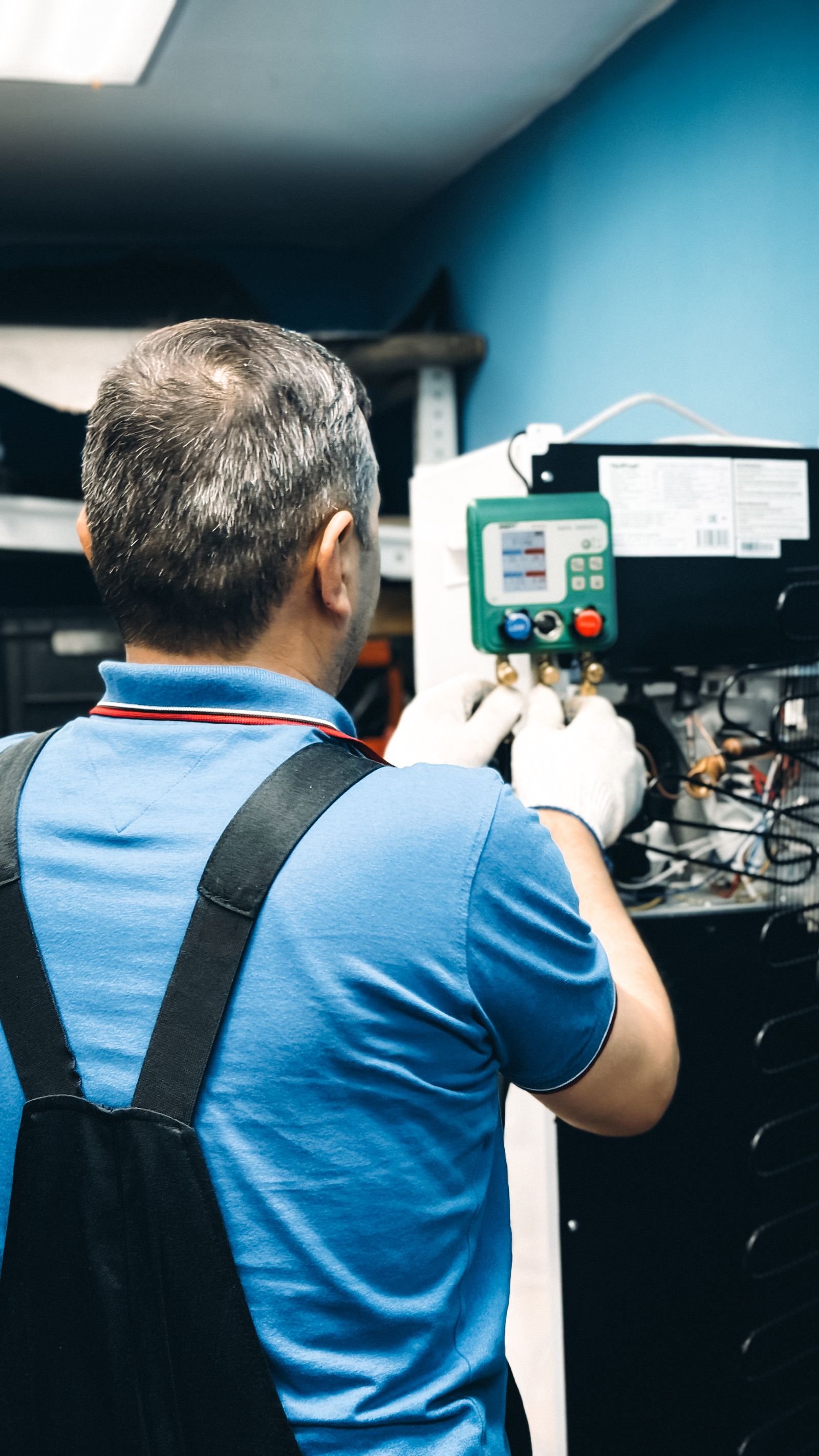 HVAC technician servicing air-conditioning equipment