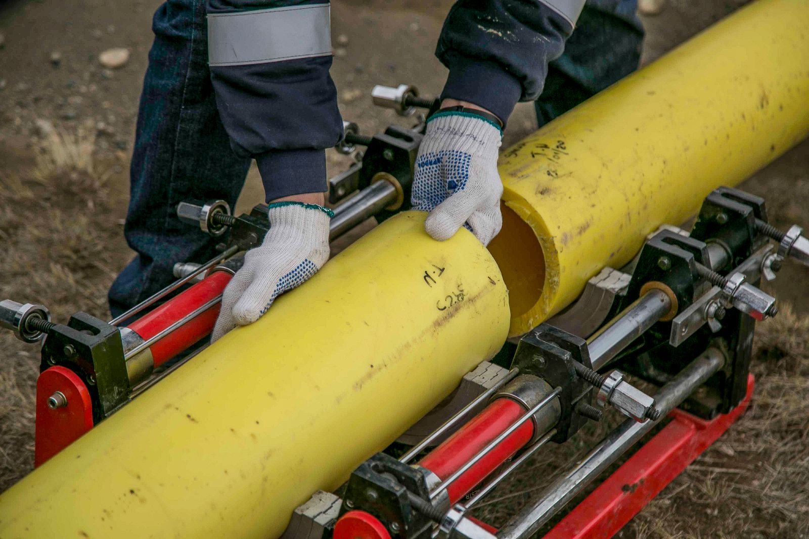 Technician handling industrial polymer piping